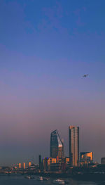 View of city skyline against sky during sunset