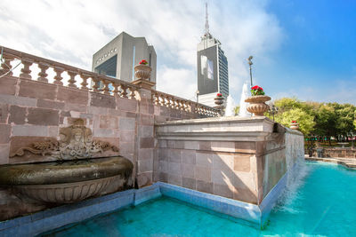 View of swimming pool by building against sky