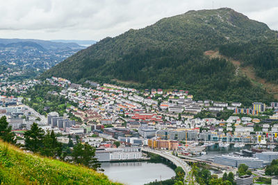 High angle view of townscape and mountains against sky