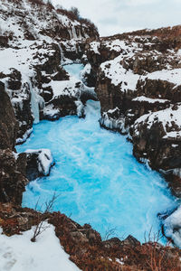 Frozen stream covered with snow