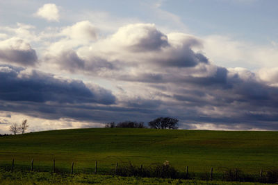 Countryside landscape against cloudy sky