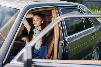 Portrait of smiling woman in car