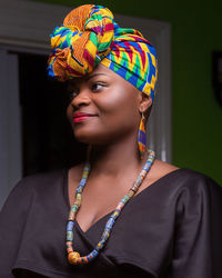 Close-up of thoughtful young woman wearing colorful headscarf