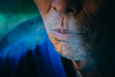 Close-up of man against blue background