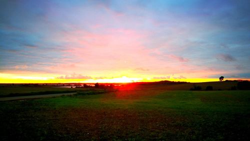 Scenic view of field against sky during sunset