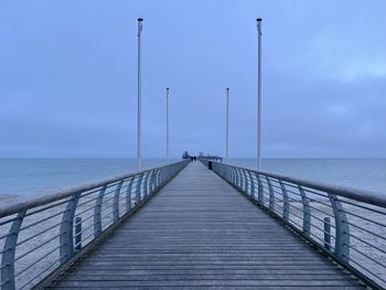 Pier over sea against sky