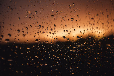 Full frame shot of wet glass window during rainy season