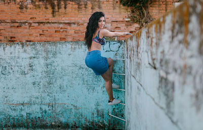 Portrait of beautiful woman standing at abandoned swimming pool