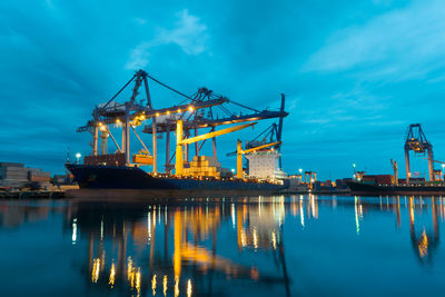 Container ship at harbor against sky