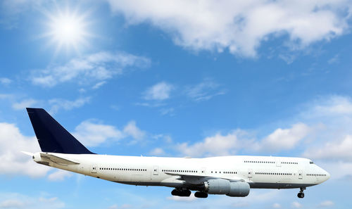 Airplane flying in the sky with beautiful sunlight.