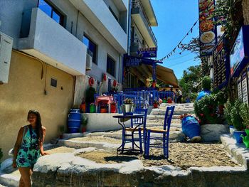 Woman sitting on chair outside house