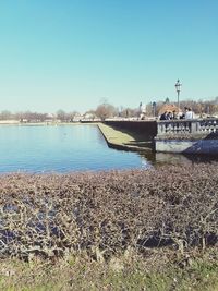 Scenic view of lake against clear blue sky