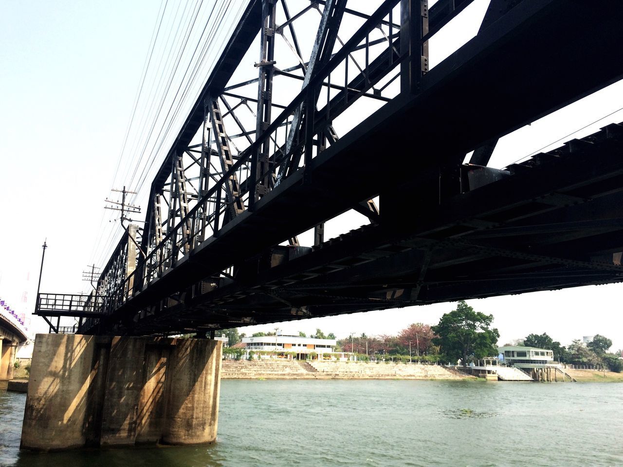 connection, built structure, bridge - man made structure, architecture, water, engineering, river, low angle view, bridge, waterfront, transportation, clear sky, sky, suspension bridge, metal, no people, day, outdoors, long, nature