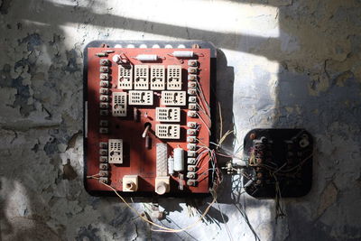 Close-up of electrical switchboard on weathered wall