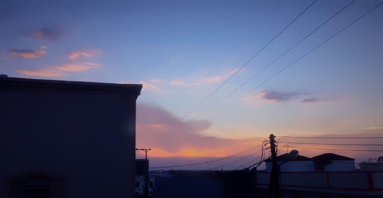 architecture, built structure, sunset, building exterior, sky, silhouette, house, cloud - sky, blue, outdoors, power line, no people, town, high section, rural scene, moody sky, tranquility, dramatic sky, scenics, majestic