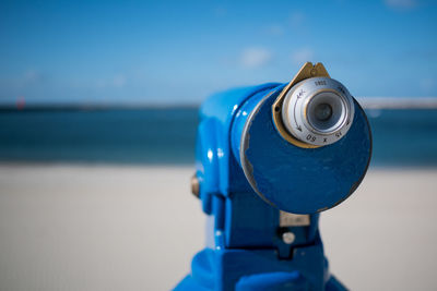 Close-up of coin-operated binoculars against blurred background