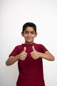 Portrait of smiling boy against white background