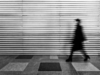 Blurred motion of people walking on zebra crossing