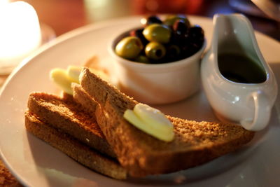 Close-up of toast and olives on table