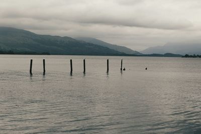 Scenic view of lake against cloudy sky