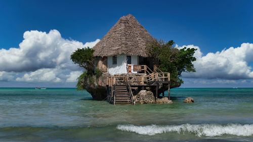 Scenic view of building on the rock in the sea