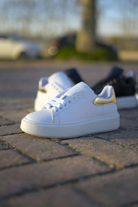 Close-up of white shoes on table