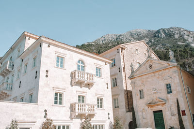 Low angle view of buildings in city against clear sky