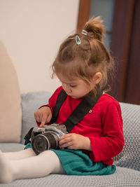 Side view of boy playing with toy at home