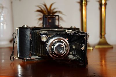 Close-up of retro camera on table at home