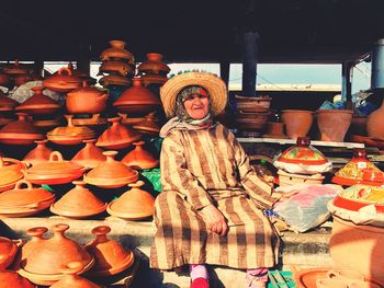 Portrait of mature woman selling clay containers