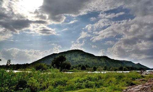 Scenic view of mountains against cloudy sky