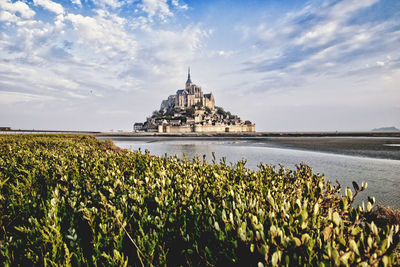 Scenic view of building against cloudy sky