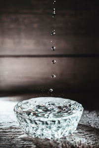 Close-up of water splashing on table