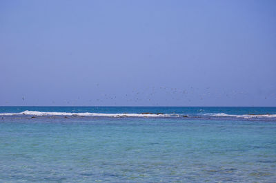 Scenic view of sea against blue sky