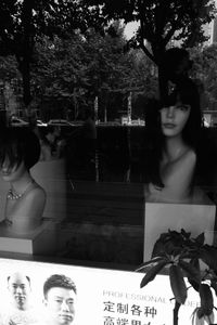 Woman standing by window at store