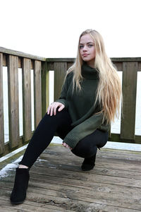 Portrait of young woman sitting on staircase