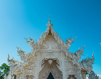 Low angle view of sculpture against blue sky