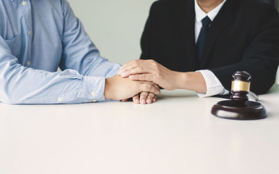 Midsection of man and woman sitting on table