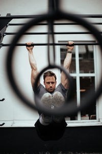 Portrait of confident man exercising in gym