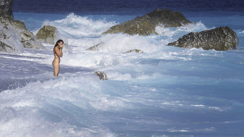 Young woman standing in sea