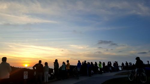 People against sky during sunset