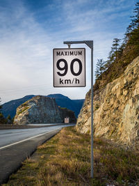 Road sign against sky