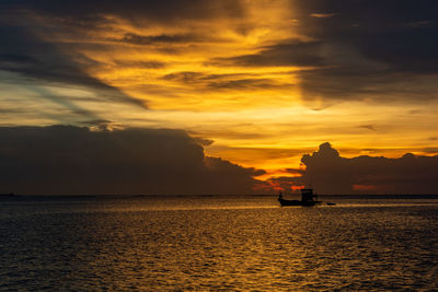 Scenic view of sea against orange sky