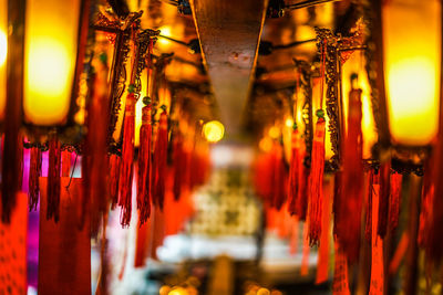 Illuminated lights hanging from ceiling of building