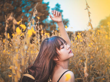 Woman looking away amidst plants