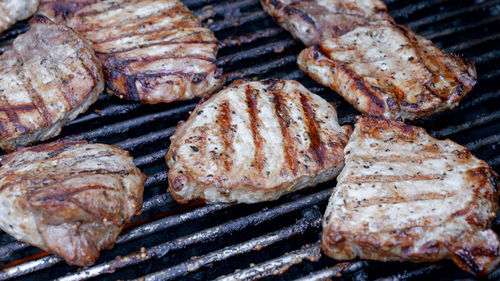 Close-up of grilled meat steak on stainless bbq grill 