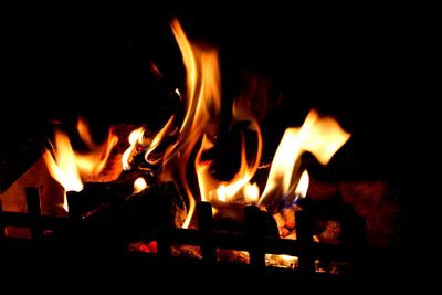 Close-up of lit candle in dark room