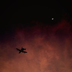 Low angle view of airplane flying in sky