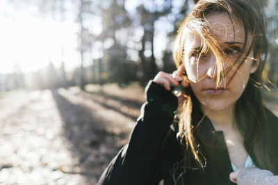 Portrait of young woman holding umbrella