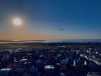 Aerial view of city against sky during sunset